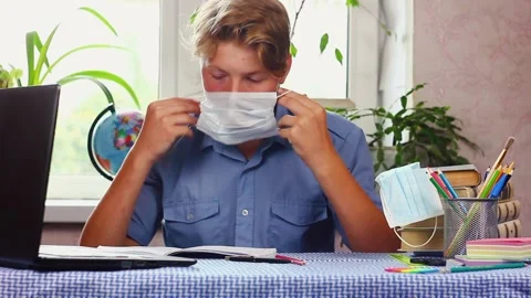 A young man sitting at a table using a laptop computer Stock Footage 142813267