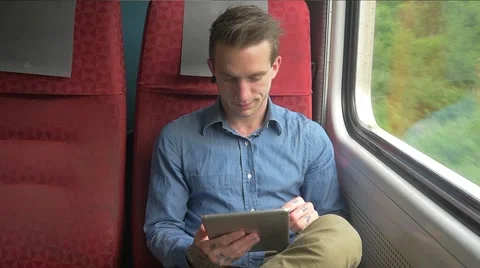 Young man sitting on the train while his tablet to do work Stockbeeldmateriaal 51832611