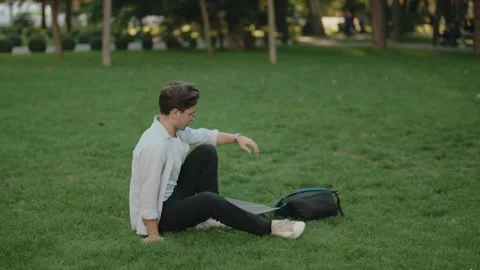 Young Man with Skateboard and Backpack in the Park Stock Footage 309115535