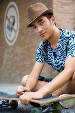 Young man with skateboard Stock Photos
