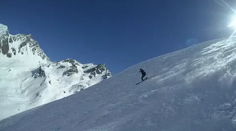 A young man skiing down a snow covered mountain , slow motion. Stock Footage 68533885