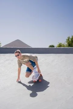 A young man skillfully skateboarding down the ramp on a surf skate, showcasing Stock Photos