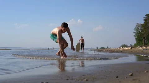 A young man skimboarding on the beach Video stock 90805833