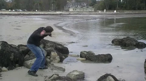 Young man skipping rocks Stock Footage 8913911
