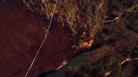 Young Man Slacklining , highlining above a big canyon  Stock Footage 85262938