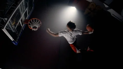 Young man slam dunks from trampoline in slow motion Video stock 123518051