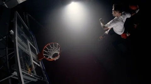 Young man slam dunks from trampoline in slow motion Video stock 123518067