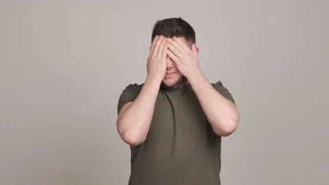 Young man slapping cheeks and rubbing face trying to recover himself Stock Footage 160964714