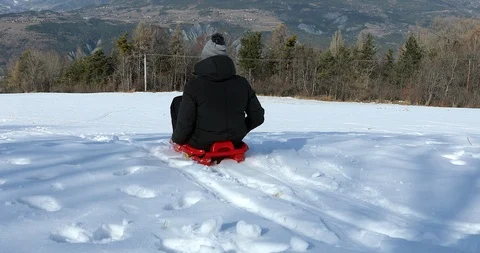 Young Man Sledding Stock Footage 123710990