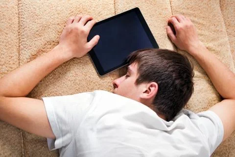 Young Man sleep with Tablet Computer Stock Photos