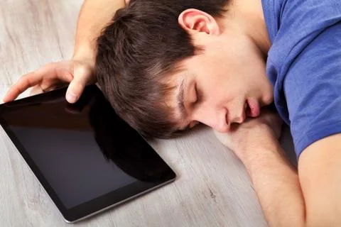 Young Man sleep with a Tablet Stock Photos