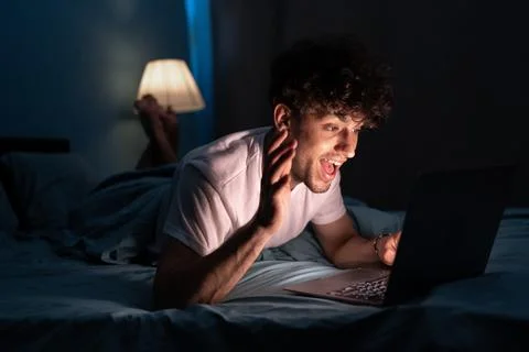 Young man sleeping and using laptop computer for social network or video co.. Stock Photos