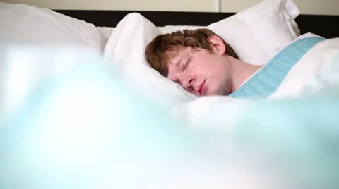 Young Man Sleeping in Bed Stock Footage 25344974