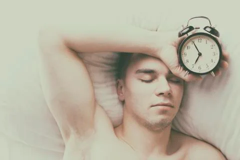 Young man sleeping in bed. Stock Photos