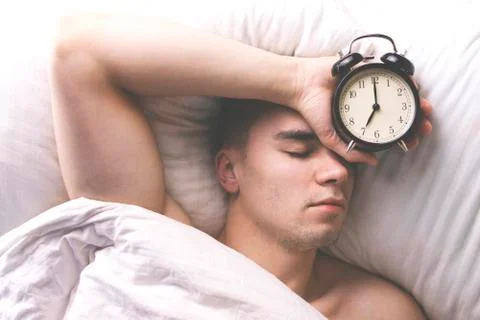 Young man sleeping in bed. Foto stock