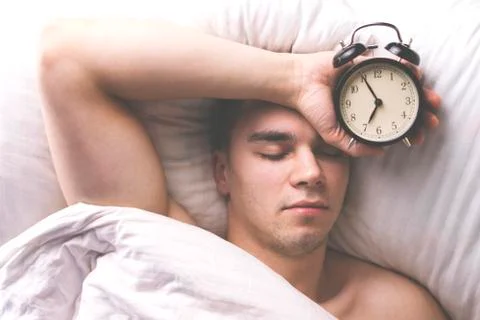 Young man sleeping in bed. Stock Photos