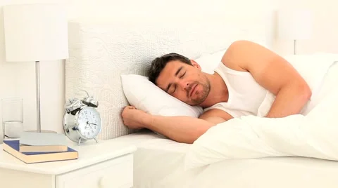 Young man sleeping on his bed Stock Footage