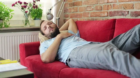 Young man sleeping on the sofa Stockbeeldmateriaal 31655546