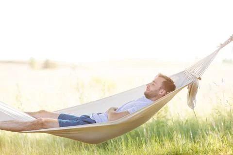 Young man sleeping in summer hammock Stock Photos