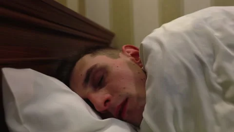 The young man sleeps peacefully. Stock Footage 167270411