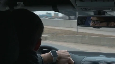 The young man slowly driving a car in the city Video stock 76150697