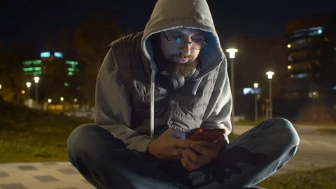 Young man with smart phone in the park Stock Footage 121964158