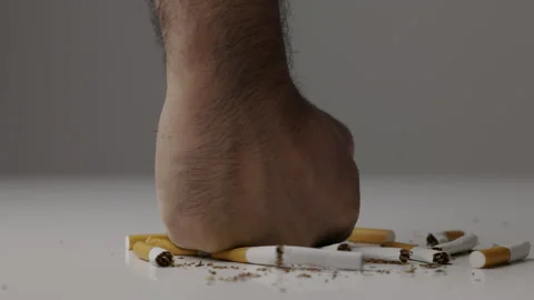 The young man smashed and smashed the cigarette with his hand. He wants to quit  Stock Footage 152766516