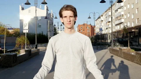 Young man smiles and throws a skateboard in hands Stock Footage 64743106