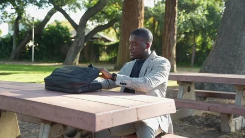Young Man Smiles As He Sets Up His Laptop, Enjoying the Calm and Open Air. Stock Footage 308481874