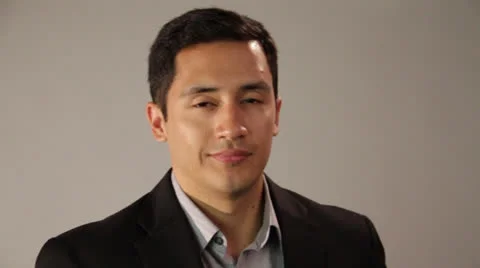 Young man smiles lightly without showing his teeth Stock Footage 22840892