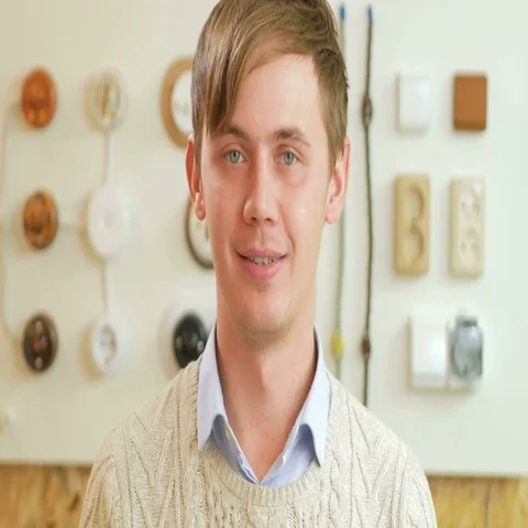 A young man smiling and looking at camera on the background of sockets and Stock Footage 69423598
