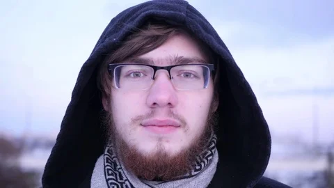 Young man smiling and looking at camera. Portrait of a happy handsome young guy Stock Footage 83288933