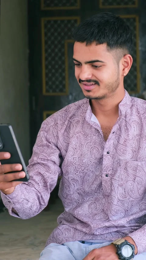 Young Man Smiling and Talking on Video Call with Smartphone Stock Footage 330738257