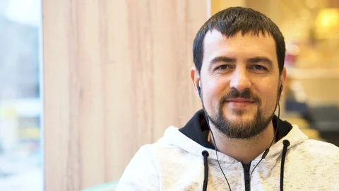 Young man smiling to camera in the cafe. Stock Footage 83664693