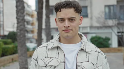 Young man smiling at camera, face visible and wearing patterned jacket on a.. Stock Footage 337423903