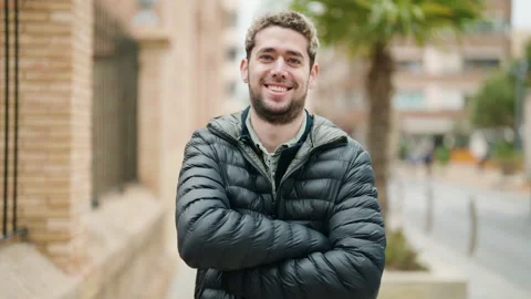 Young man smiling confident standing with arms crossed gesture at street Video stock 171039702