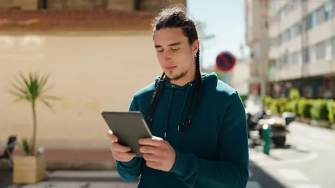 Young man smiling confident using touchpad at street Video stock 172071042
