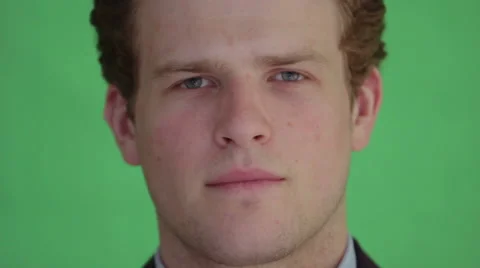 Young man smiling in front of greenscreen Stock Footage 40960509