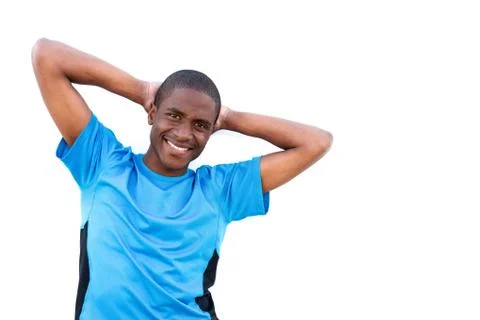 Young man smiling with hands behind head on isolated white background Foto stock
