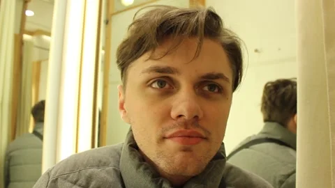 Young man is smiling sitting at dressing room Stock Footage 123725055