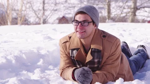 Young man smiling in the snow Stock Footage 80128495
