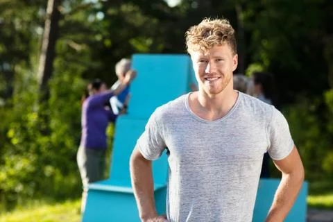 Young Man Smiling While Friends Making Planks Pyramid 写真素材