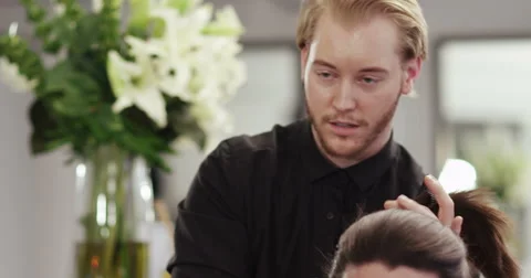 A young man smiling while having a consultation with his hair stylist. Stock Footage 59737878