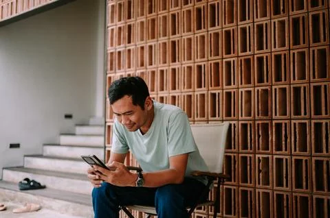 Young man smiling while using smartphone outdoors Stock-Fotos