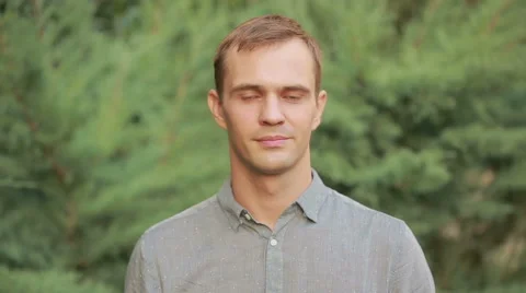 Young man smiling with yellow teeth. stroking the neck Stock Footage 68525978
