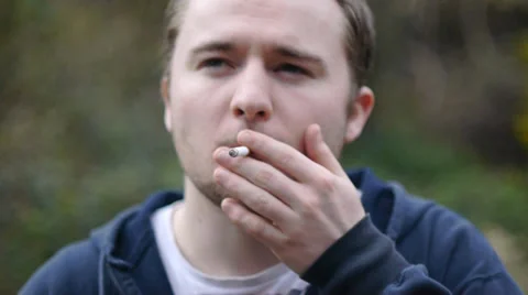 Young Man Smokes Cigarette Stock Footage 37037596