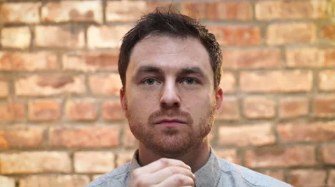 A young man smokes an e cigarette indoors Video stock 62813264