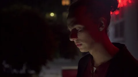 Young man smoking and using smartphone outdoors at night 1 Stock Footage 95864212