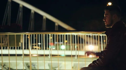 Young man smoking cigarette on a bridge at the night Vídeo Stock 61096237