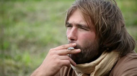 Young man smoking a cigarette Stock Footage 8562111